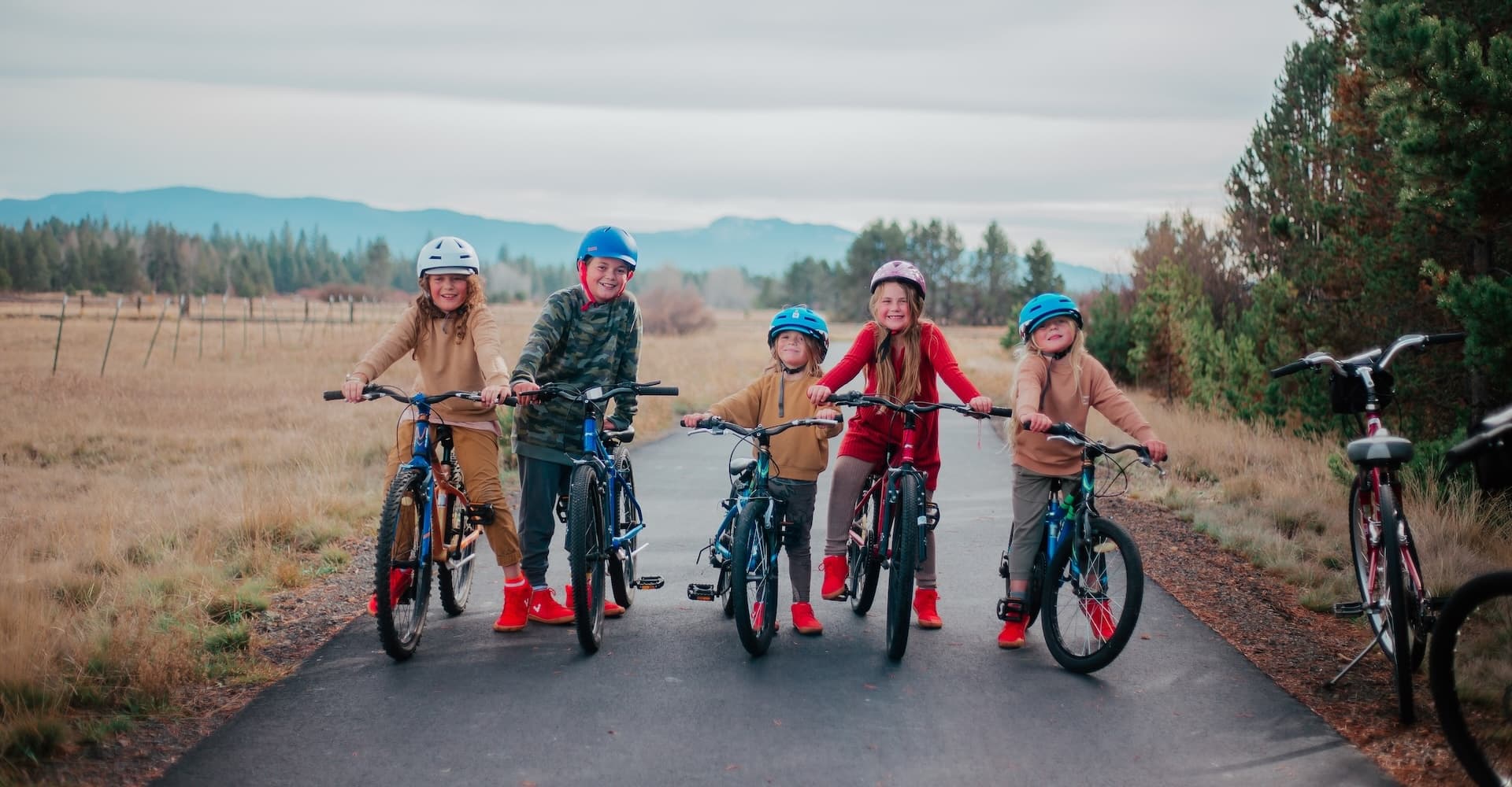 a group of kids on bicycles posing for a picture