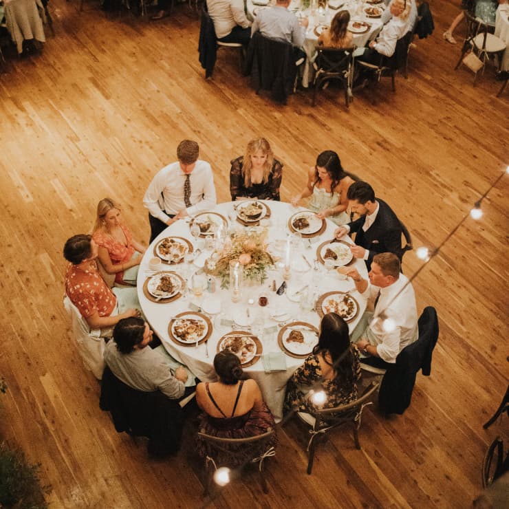 people at a dinner table while at a wedding